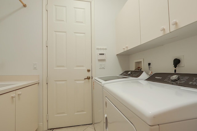 washroom featuring independent washer and dryer and cabinet space