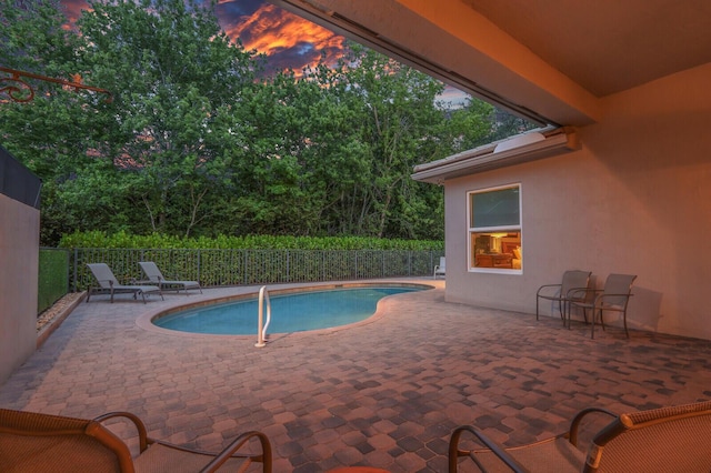 view of swimming pool featuring fence, a fenced in pool, and a patio area