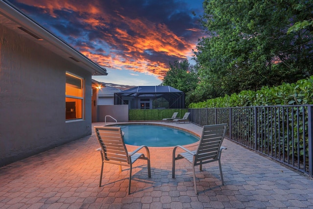 view of swimming pool featuring a patio, fence, and a fenced in pool