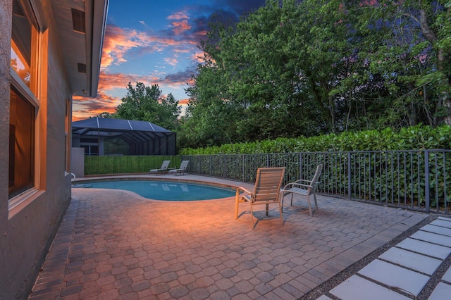 view of swimming pool featuring fence, a fenced in pool, and a patio area