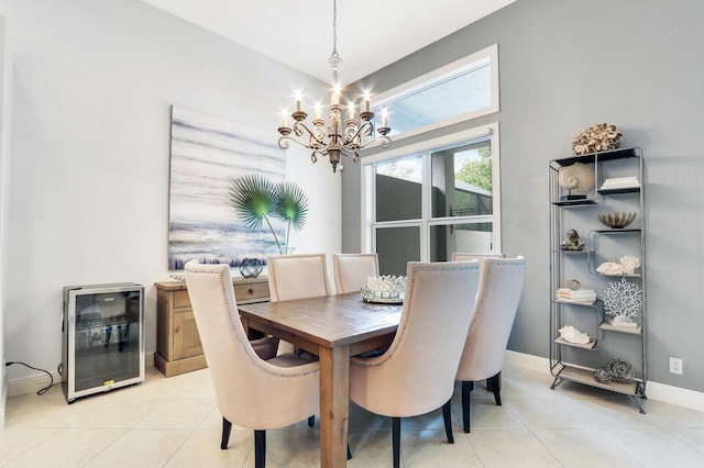 dining area with wine cooler, light tile patterned flooring, baseboards, and a chandelier