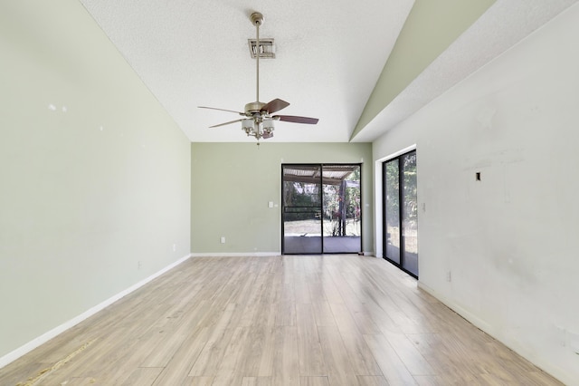 unfurnished room with ceiling fan, visible vents, vaulted ceiling, baseboards, and light wood finished floors