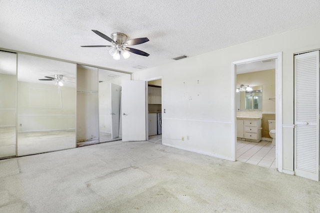 unfurnished bedroom featuring visible vents, a textured ceiling, and carpet