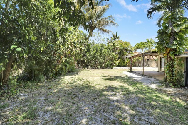 view of yard featuring a patio, a pergola, and a fenced backyard