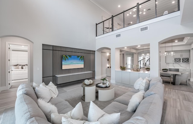 20136 Se Bridgewater Drive Livingston Model, Jupiter, FL 33458 - living area featuring arched walkways, a high ceiling, a chandelier, and visible vents