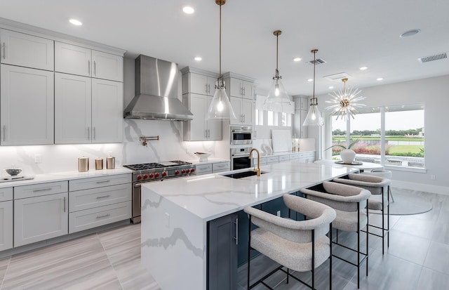 20136 Se Bridgewater Drive Livingston Model, Jupiter, FL 33458 - kitchen featuring appliances with stainless steel finishes, a sink, wall chimney exhaust hood, recessed lighting, and visible vents