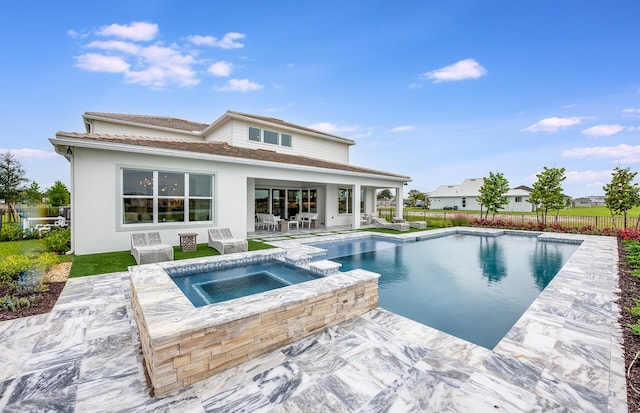 20136 Se Bridgewater Drive Livingston Model, Jupiter, FL 33458 - back of house featuring a pool with connected hot tub, fence, a patio area, and stucco siding