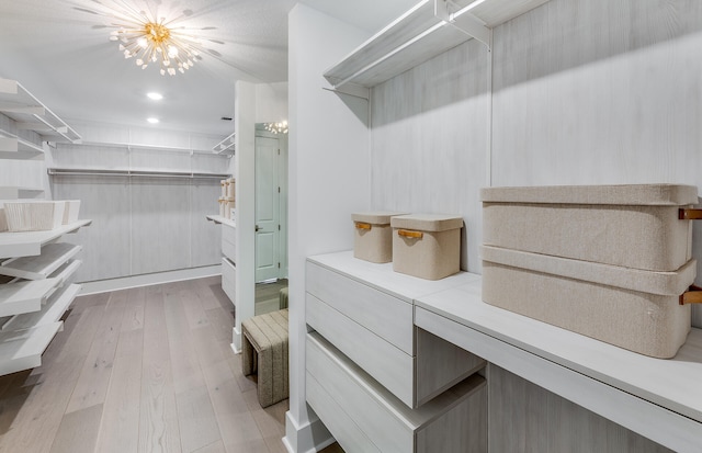 20136 Se Bridgewater Drive Livingston Model, Jupiter, FL 33458 - walk in closet with an inviting chandelier and wood finished floors