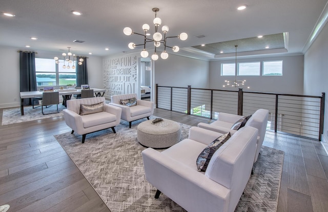 20136 Se Bridgewater Drive Livingston Model, Jupiter, FL 33458 - living room featuring a healthy amount of sunlight, hardwood / wood-style flooring, and a chandelier
