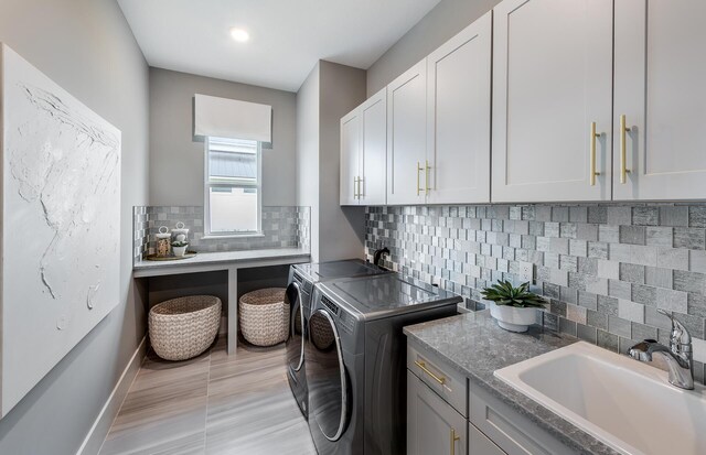 20136 Se Bridgewater Drive Livingston Model, Jupiter, FL 33458 - laundry room with baseboards, recessed lighting, separate washer and dryer, a sink, and cabinet space