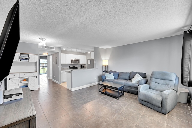 1625 Meadows Cir W, Boynton Beach, FL 33436 - living room featuring light tile patterned flooring and a textured ceiling