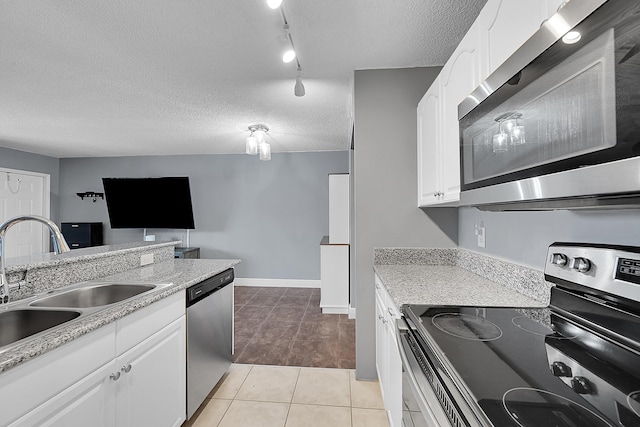 1625 Meadows Cir W, Boynton Beach, FL 33436 - kitchen featuring appliances with stainless steel finishes, a sink, white cabinets, a textured ceiling, and light tile patterned flooring