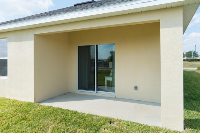 12134 SW Rimini Way, Port Saint Lucie, FL 34987 - back of house with a patio, a shingled roof, a lawn, and stucco siding