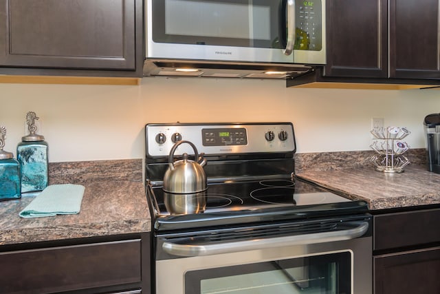 12134 SW Rimini Way, Port Saint Lucie, FL 34987 - kitchen featuring stainless steel appliances, dark brown cabinetry, and dark countertops