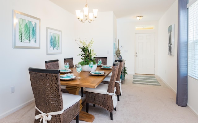 12134 SW Rimini Way, Port Saint Lucie, FL 34987 - dining space with baseboards, carpet, and a chandelier
