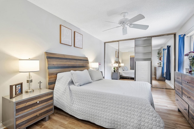 bedroom featuring ceiling fan, a closet, and wood finished floors
