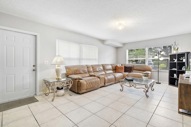 living room featuring a textured ceiling and light tile patterned flooring