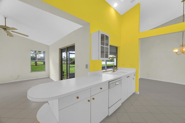 kitchen featuring white dishwasher, light tile patterned floors, plenty of natural light, and a sink