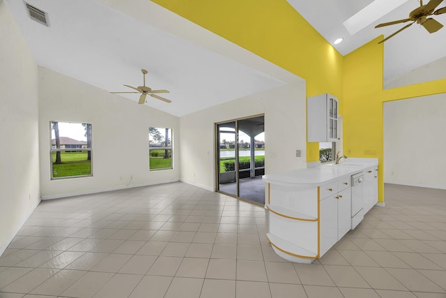 kitchen featuring a sink, high vaulted ceiling, ceiling fan, and a wealth of natural light