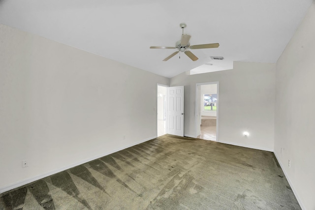 carpeted spare room featuring baseboards, ceiling fan, vaulted ceiling, and visible vents