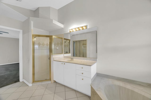 bathroom with vanity, a garden tub, a stall shower, and tile patterned flooring