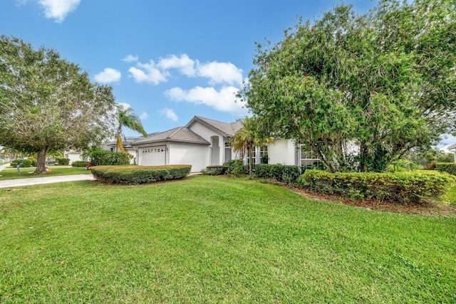 view of front of house featuring a garage, stucco siding, concrete driveway, and a front lawn