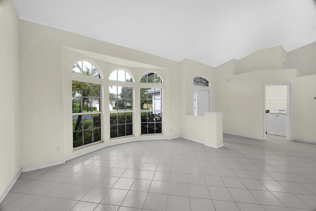 unfurnished living room featuring baseboards, vaulted ceiling, and tile patterned flooring