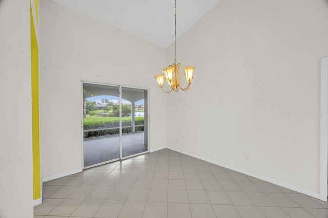 spare room with high vaulted ceiling, a notable chandelier, and baseboards