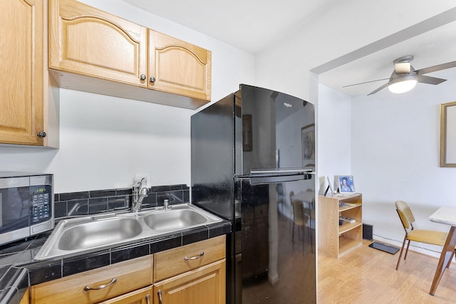 2520 S Federal Hwy Unit 14, Boynton Beach, FL 33435 - kitchen with a sink, freestanding refrigerator, a ceiling fan, stainless steel microwave, and wood finished floors