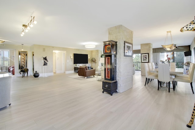 living room featuring baseboards and light wood finished floors