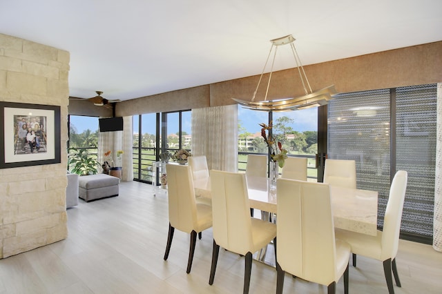 dining area with ceiling fan with notable chandelier