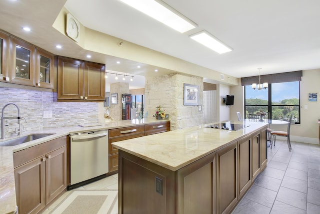 kitchen with backsplash, dishwasher, a sink, black electric stovetop, and a chandelier