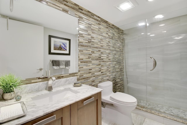 full bathroom featuring backsplash, tile walls, a stall shower, vanity, and toilet