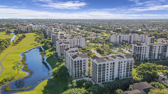 birds eye view of property with a water view and golf course view