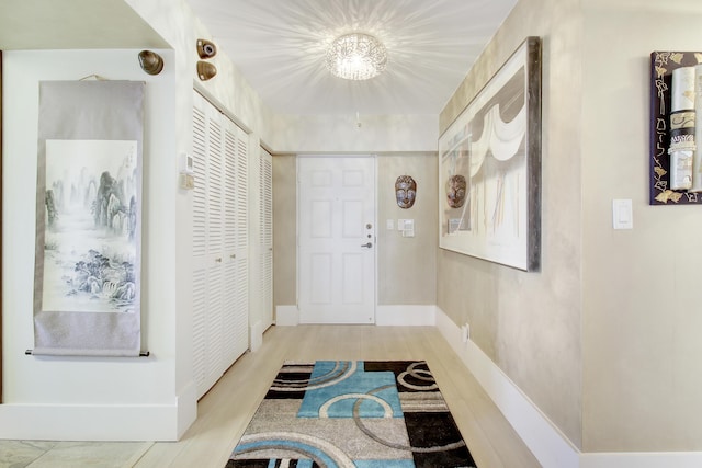 interior space featuring baseboards and wood finished floors