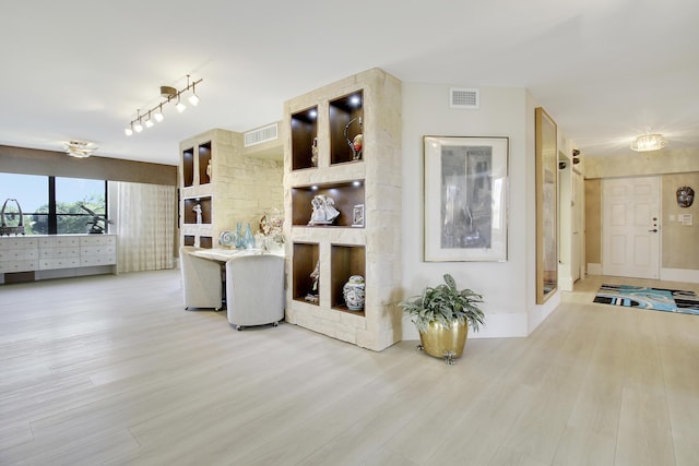 living room with baseboards, wood finished floors, and visible vents