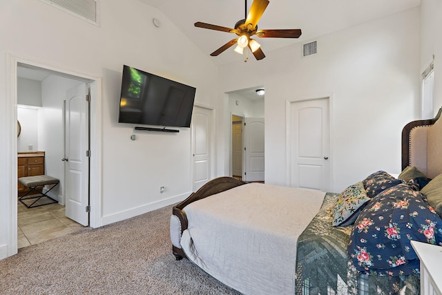carpeted bedroom featuring visible vents, baseboards, tile patterned floors, and high vaulted ceiling