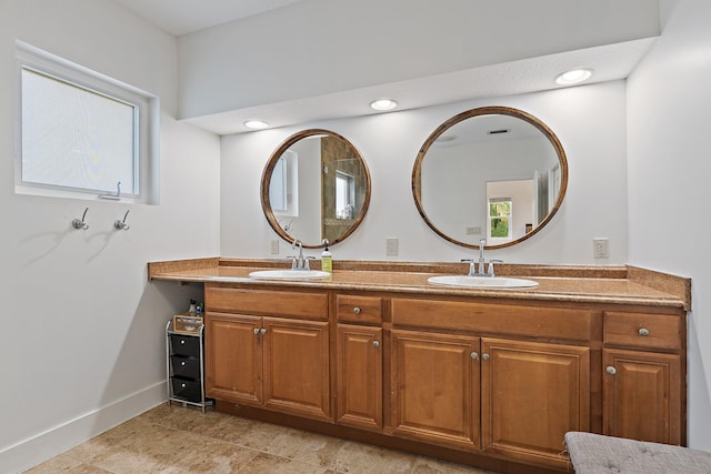 full bathroom with a sink, baseboards, recessed lighting, and double vanity
