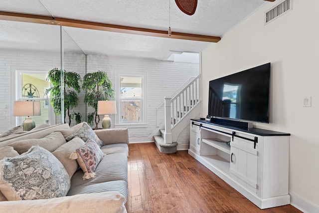 living room with visible vents, baseboards, ceiling fan, and hardwood / wood-style floors