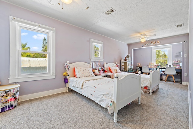 bedroom with carpet, a textured ceiling, and visible vents