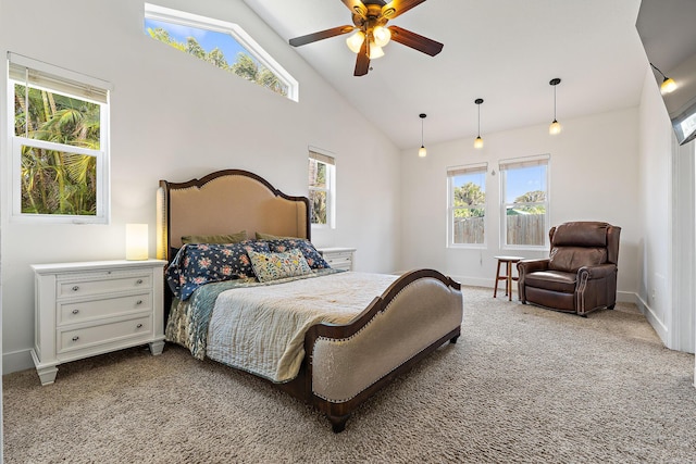 carpeted bedroom featuring high vaulted ceiling, multiple windows, and baseboards