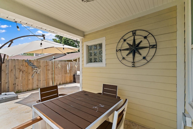 view of patio featuring fence and outdoor dining space