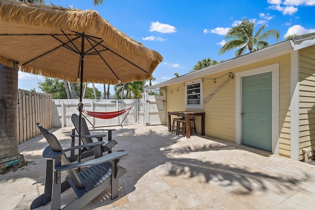 view of patio / terrace featuring fence and a gate