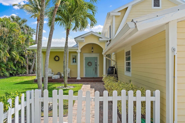 view of front of property with a porch, a fenced front yard, and a front yard