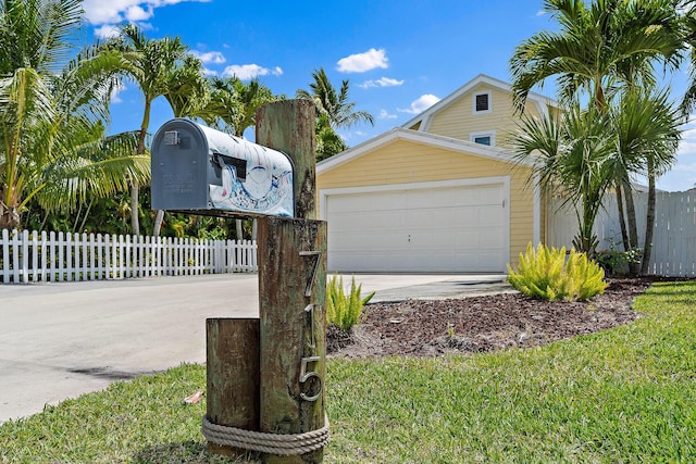 exterior space featuring fence, driveway, and a garage