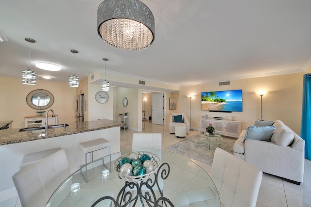 dining area featuring visible vents, baseboards, crown molding, and light tile patterned floors