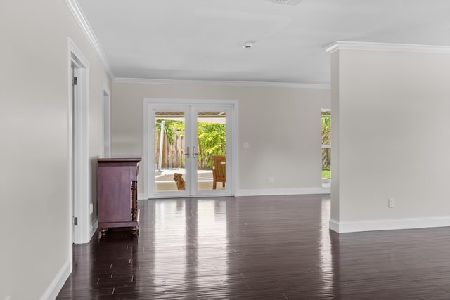 unfurnished room with french doors, dark wood finished floors, crown molding, and baseboards