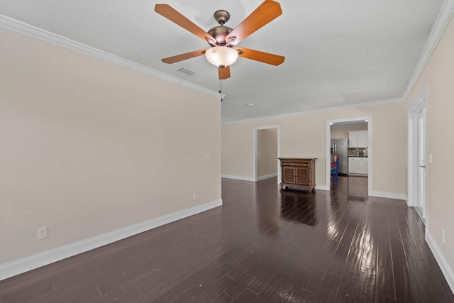 unfurnished living room with baseboards, ornamental molding, a ceiling fan, and dark wood finished floors