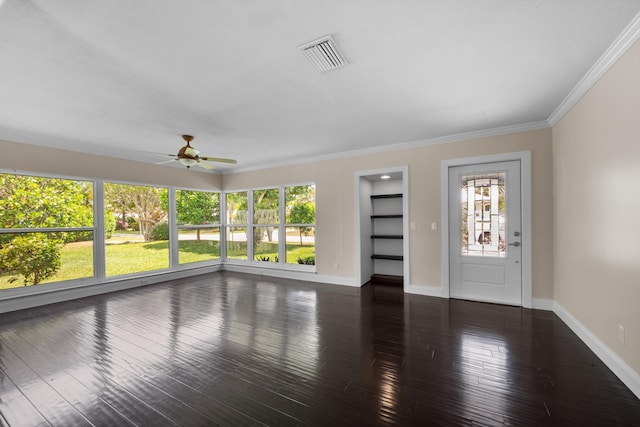 unfurnished living room with ceiling fan, baseboards, wood finished floors, and crown molding