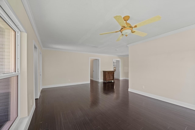 empty room with crown molding, wood finished floors, baseboards, and a ceiling fan